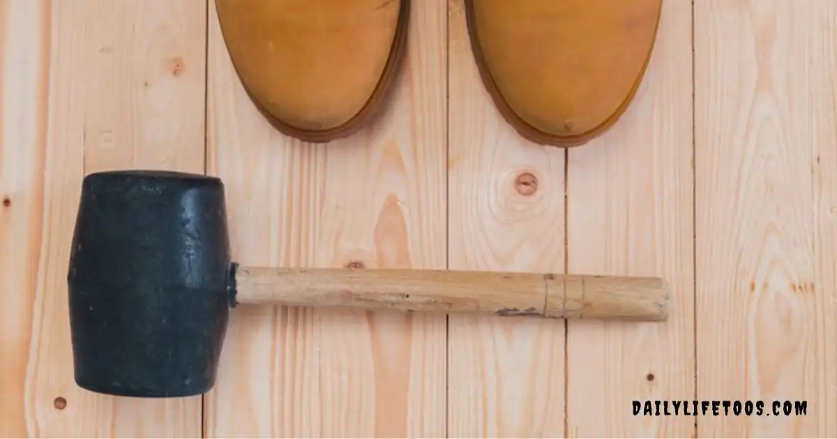 A rubber mallet and a wood chisel lying on a wooden surface, illustrating the correct tool for striking a wood chisel.