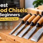 Five wood chisels arranged on a woodworking bench for beginners