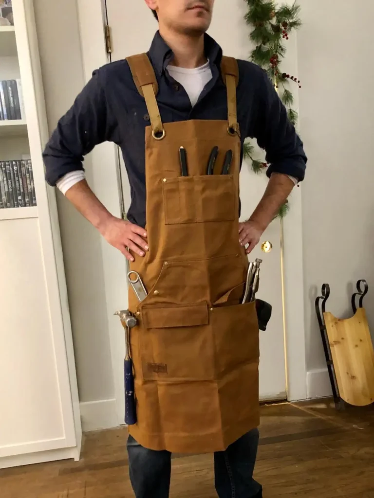 Brown woodworking apron under $50 filled with tools.