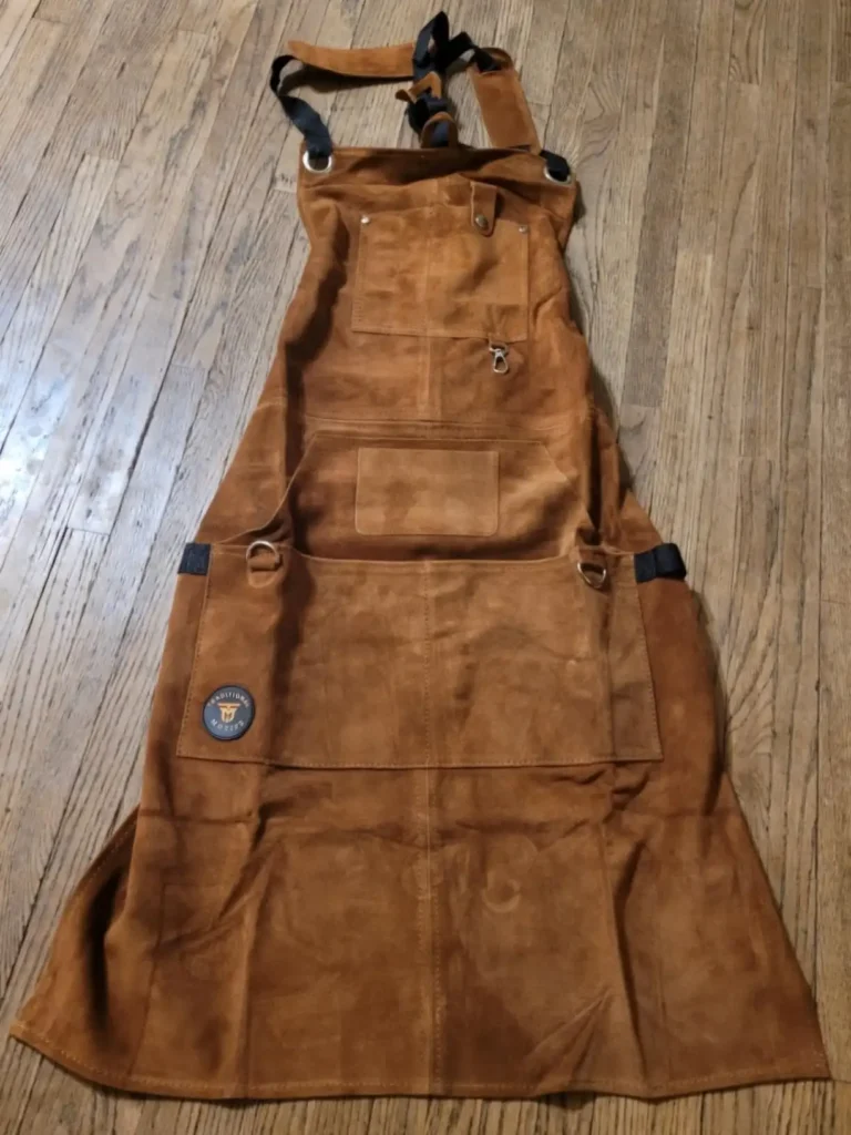 Brown leather woodworking apron suitable for blacksmithing.