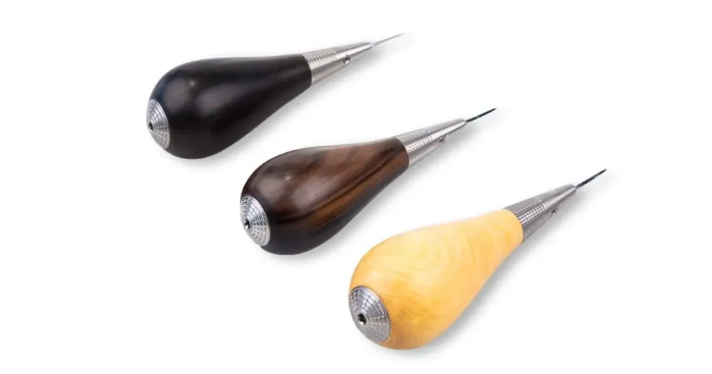 Three elegant wood awls with varying shades of exotic wood handles and sharp metal tips, arranged diagonally on a white background.