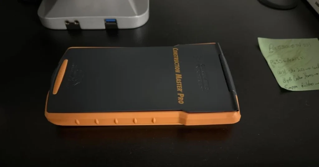 Closed Calculated Industries Construction Master Pro calculator in its protective case, a portable tool for carpenters to calculate accurate quotes and measurements on construction sites.